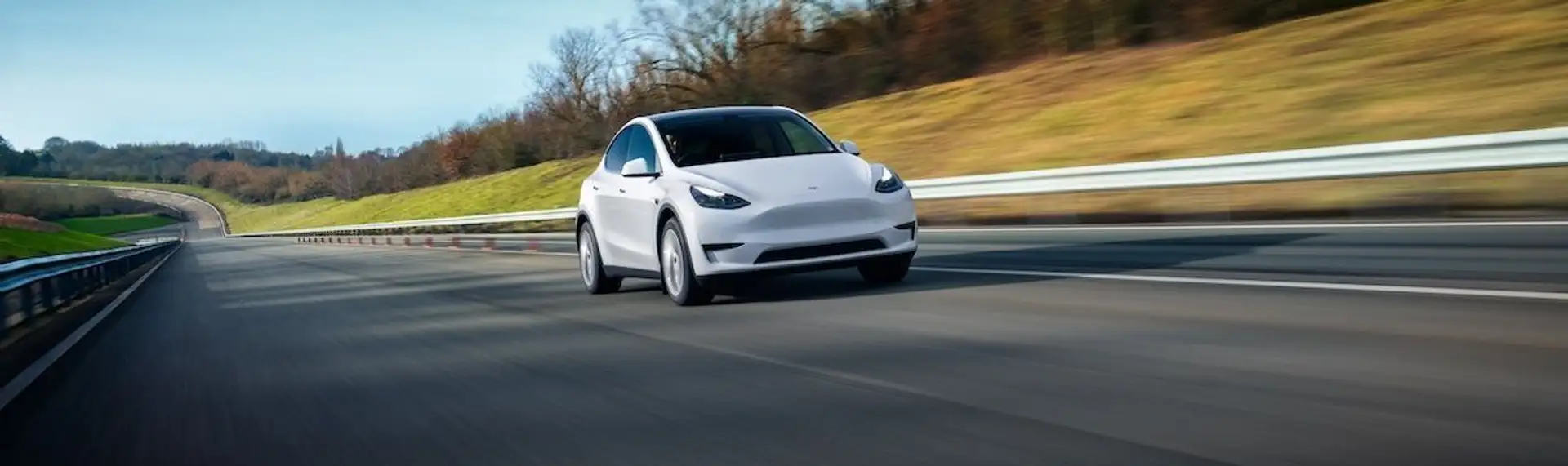 A white Tesla Model Y photographed from the front on a highway - courtesy of Tesla Inc.